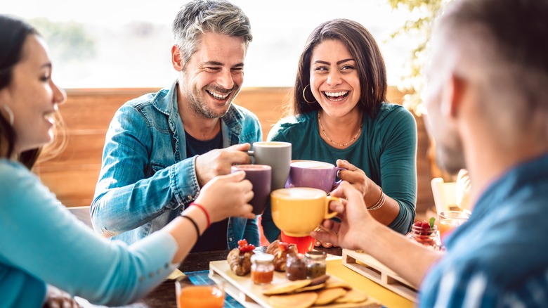 Friends laughing at table