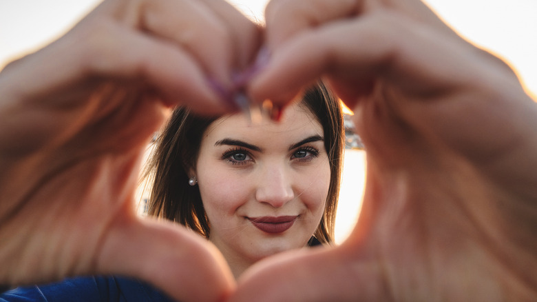 woman making heart with hands