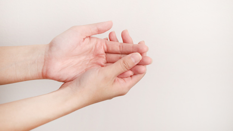 One hand cupping the other