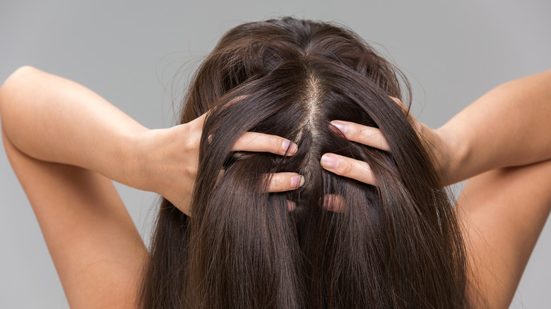 woman massaging her scalp