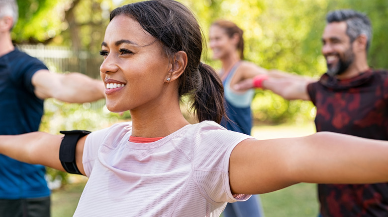 People stretching wearing sportswear outdoors