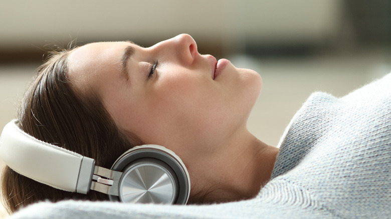 female relaxing wearing headphones