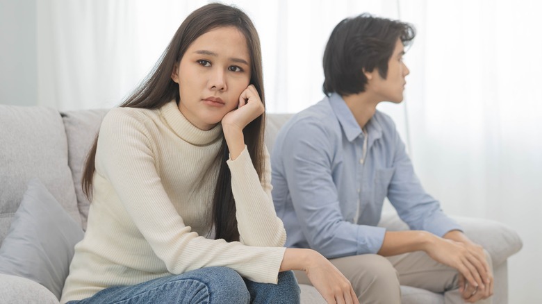 sad couple sitting on couch