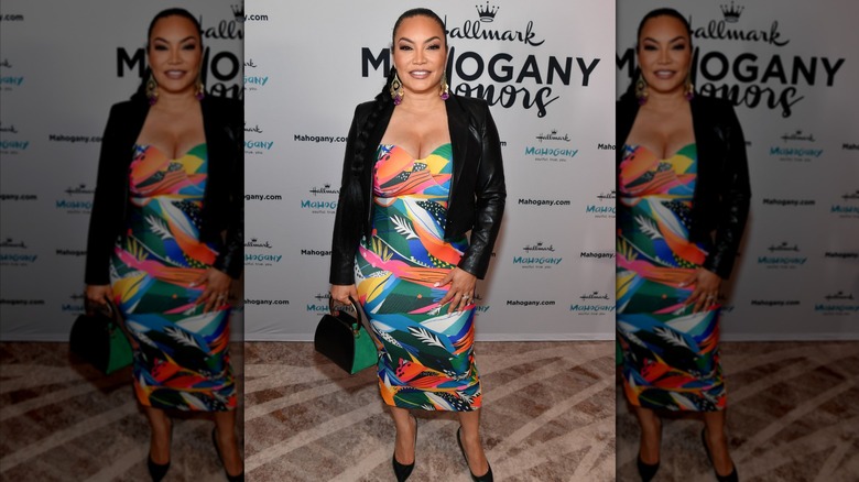 Egypt Sherrod wearing a bright patterned dress with a black blazer at a brunch