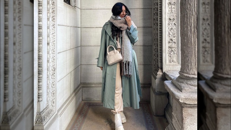 Model wearing earthy neutral winter accessories