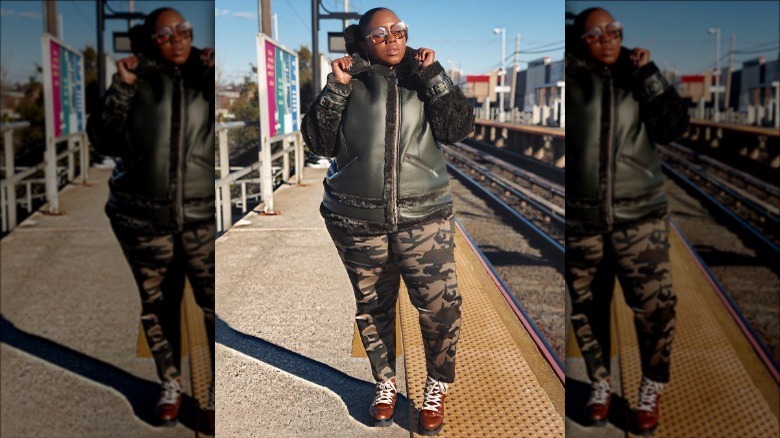 Model wearing camoflauge leggings and leather jacket