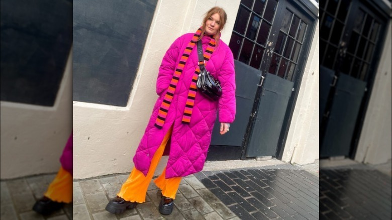 Model wearing neon pink and orange outfit