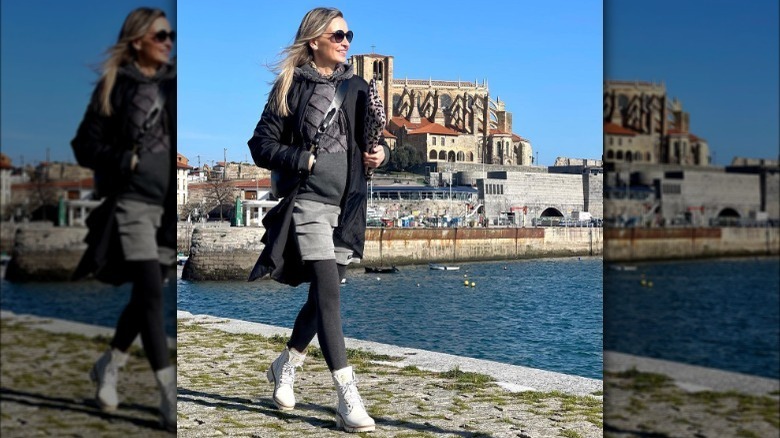 Model wearing grey sportswear and white boots
