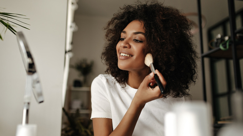 Woman applying her makeup