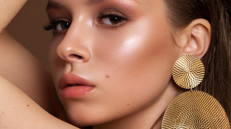 girl wearing large gold earrings 