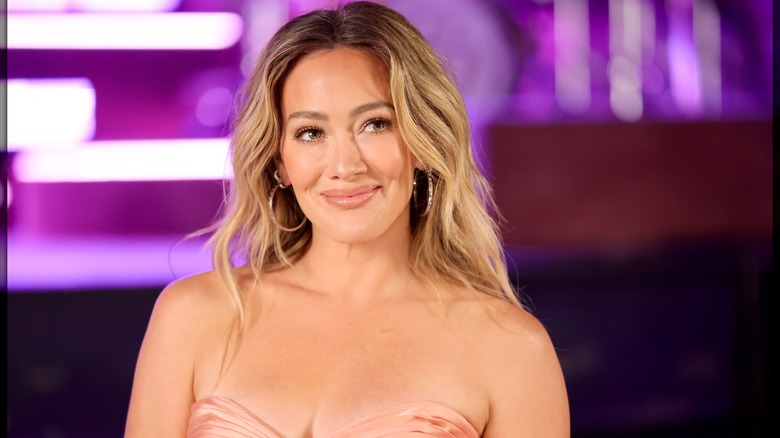 Hilary Duff smiling with dark roots in 2026