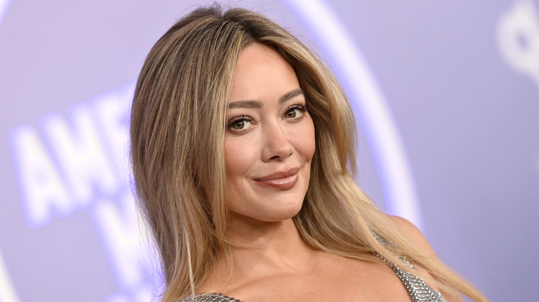 Hilary Duff posing on a red carpet in 2026