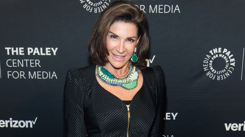 Hilary Farr posing for photos in a black jacket