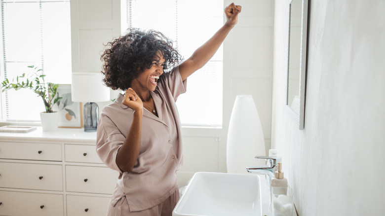 Happy woman staring bathroom