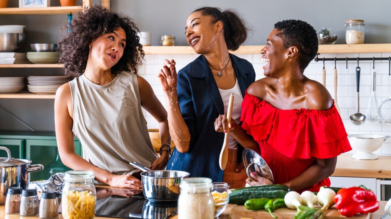 three women cooking in kitchen