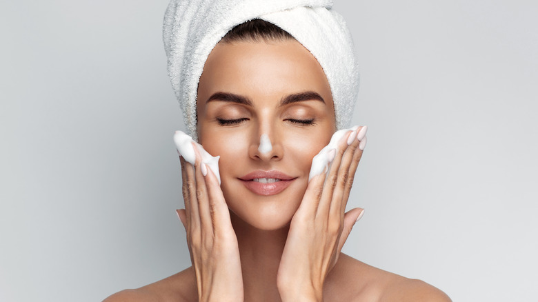 woman putting soap on face