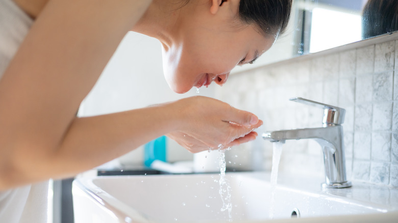 woman washing her face