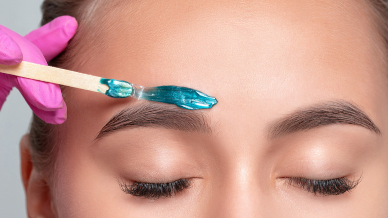 woman having eyebrows waxed