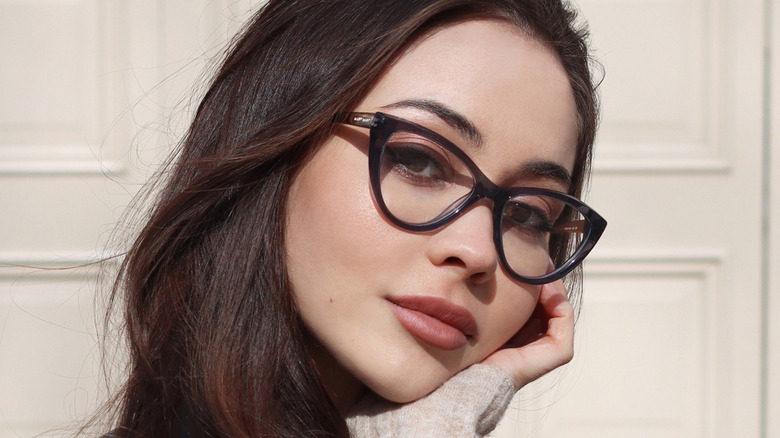 Model wearing black cat-eye glasses