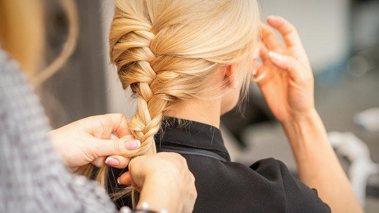 Blond hair being braided