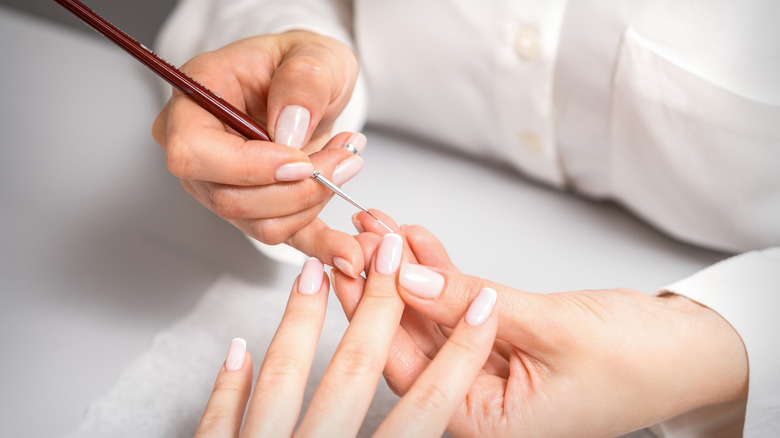 manicurist working on nails