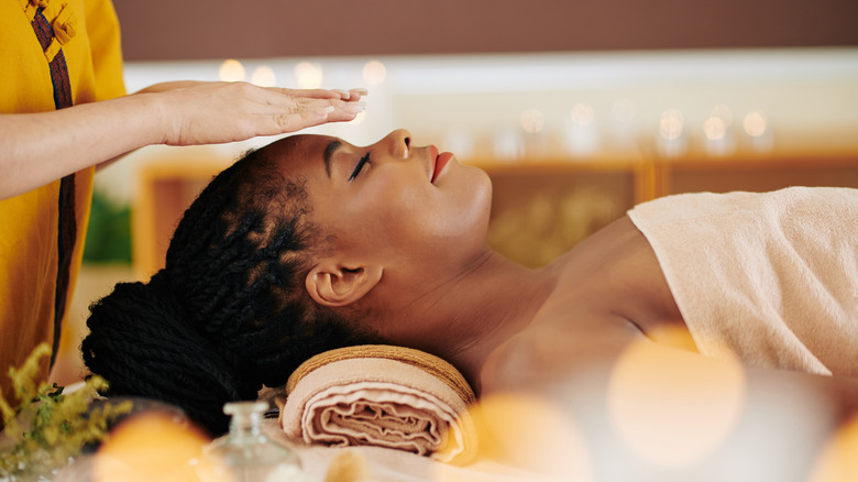 Woman receiving reiki treatment