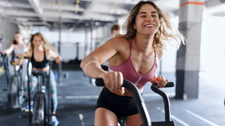 Women working out on bikes at the gym 