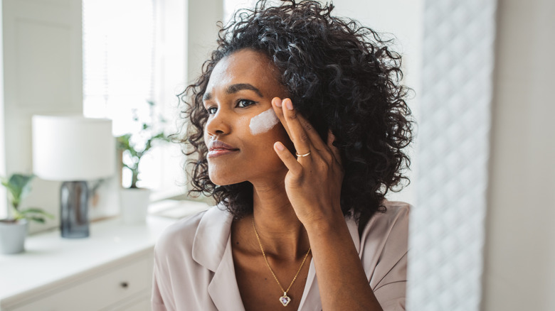 Woman applying skincare cream