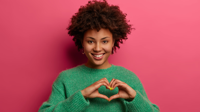 woman holding hands in heart