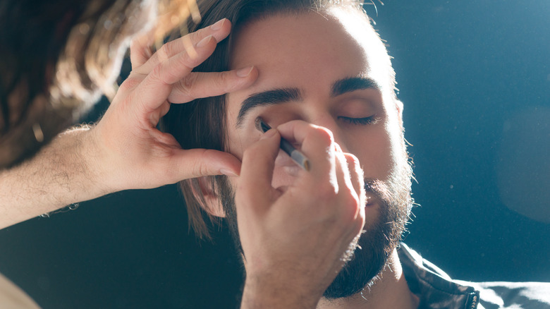 Man getting his makeup done