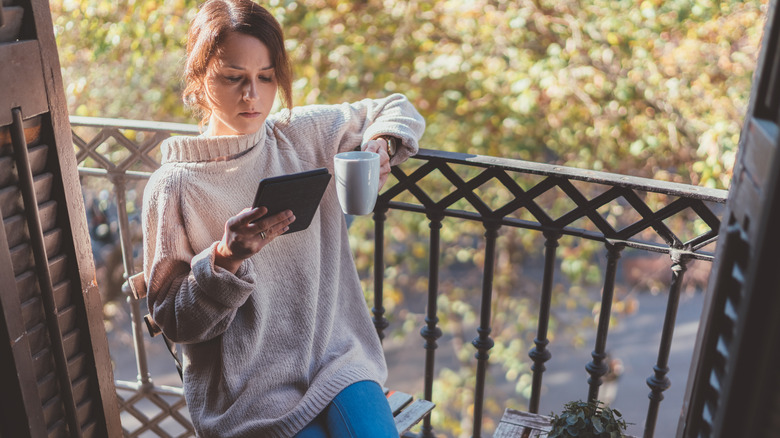 Woman with e-reader on deck