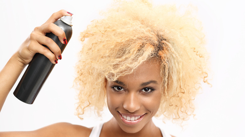 woman spraying curly hair