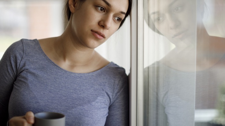 woman looking out window