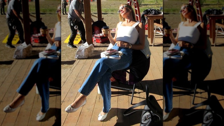 Elle Chapman resting in the sun with a coffee cup