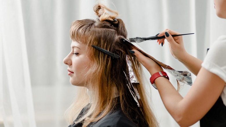 woman dying hair in salon