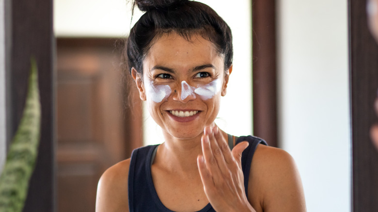 Woman applying sunscreen