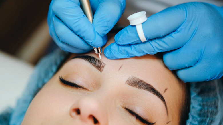 person having their brows microbladed