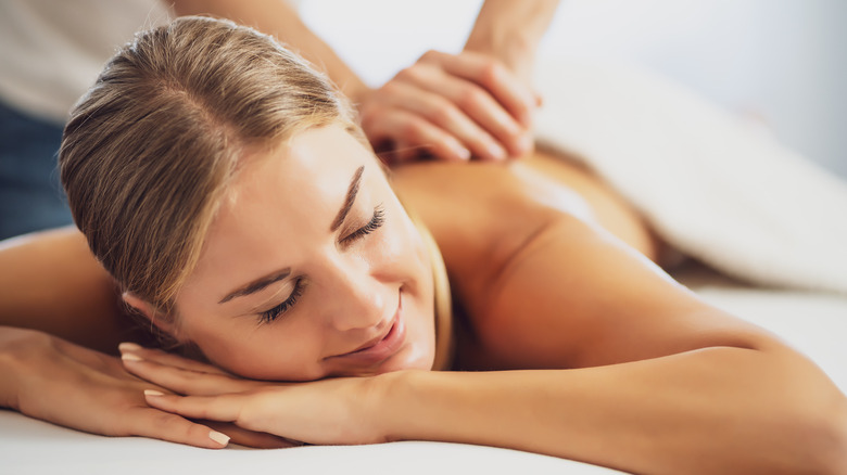 Woman receiving back massage