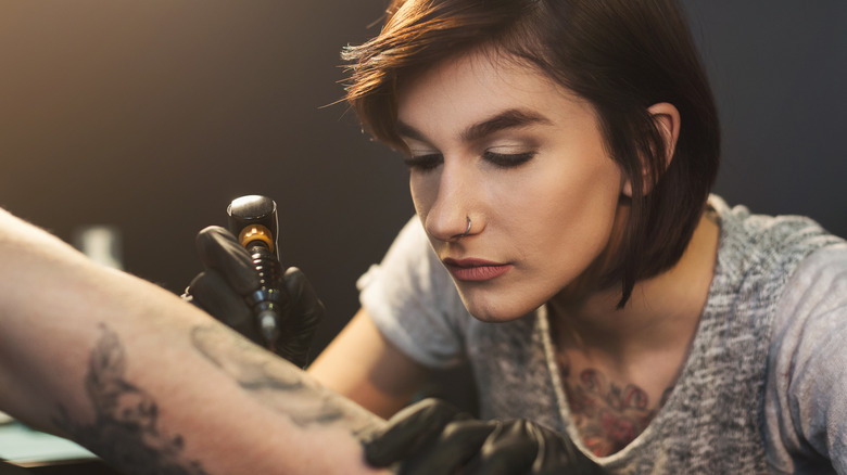 Female tattoo artist working