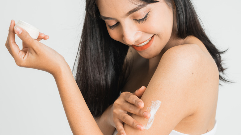 Woman applying makeup SPF