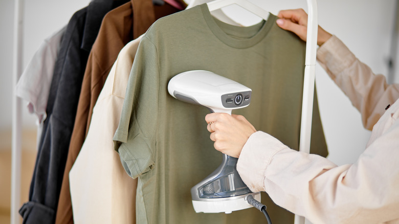 person steaming olive green shirt