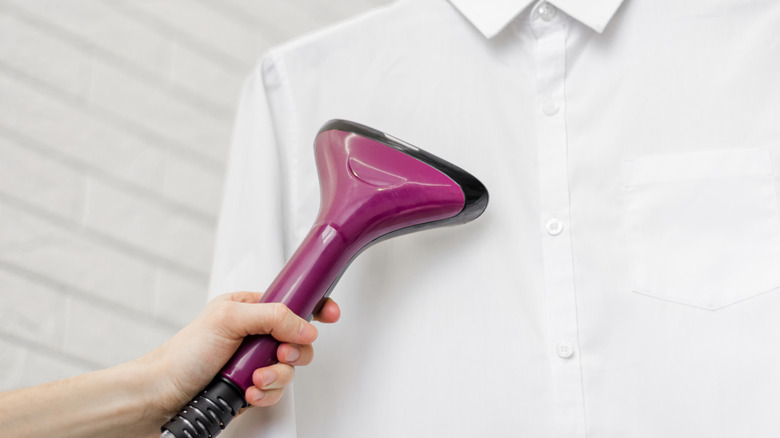 person steaming white shirt