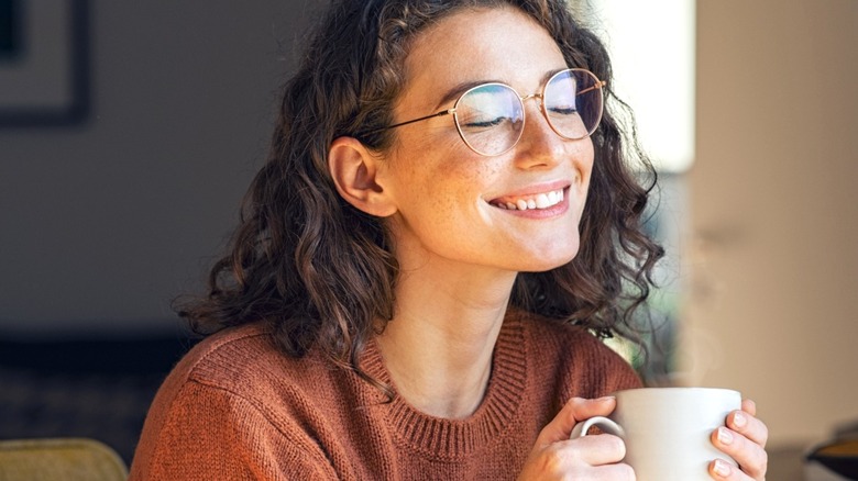 Girl holding mug and smiling