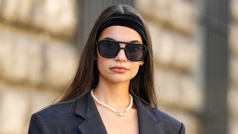 Girl wearing Vivienne Westwood pearl necklace.