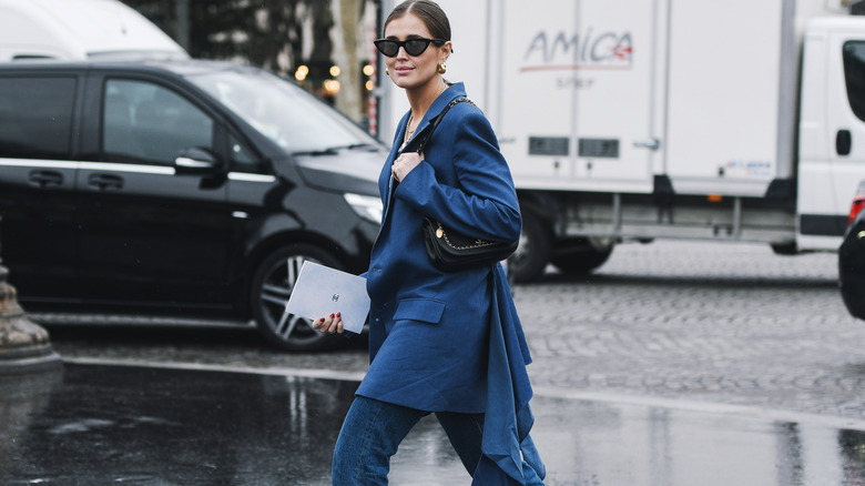 woman walking in Paris with denim jeans and loose blazer