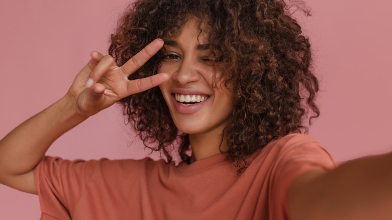 Girl with curly hair smiling.