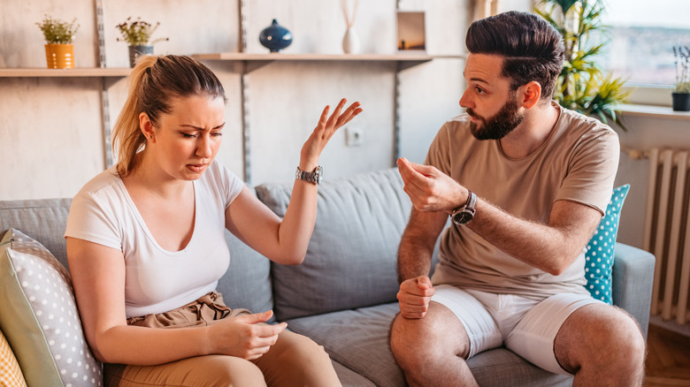 couple arguing on sofa