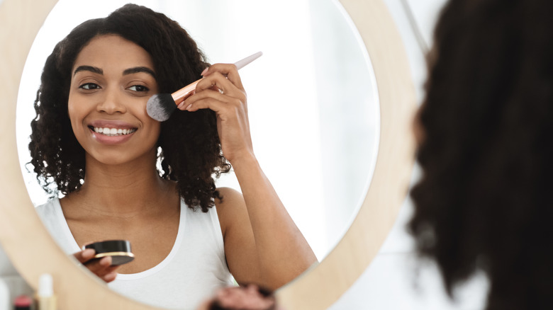 Woman applying blush 