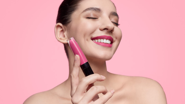 woman holding liquid lipstick