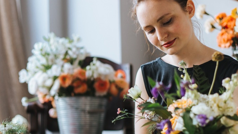 Woman arranging fresh cut flowers